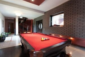 pool table in a home game room with a brick wall
